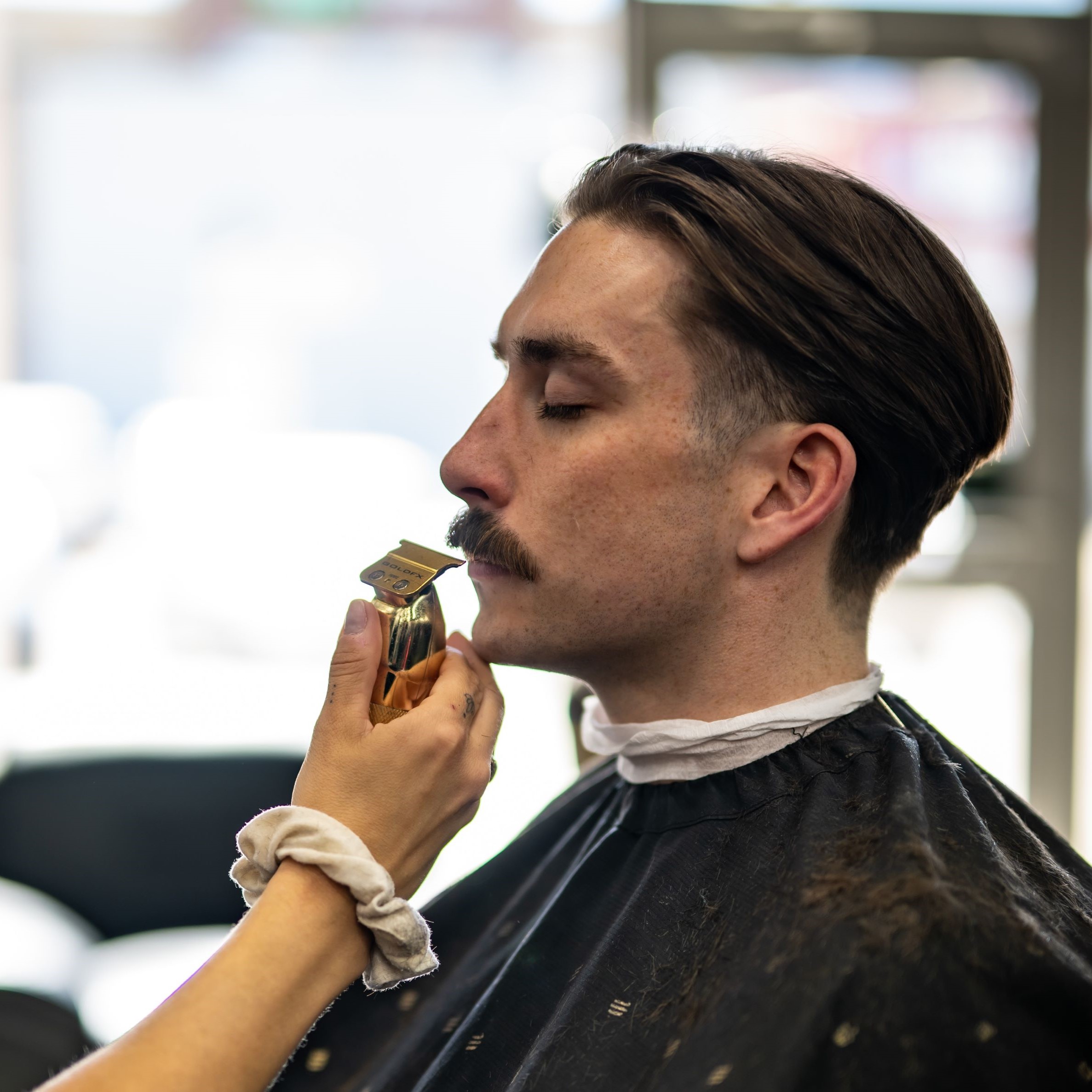 professional barber shaping hair based on density